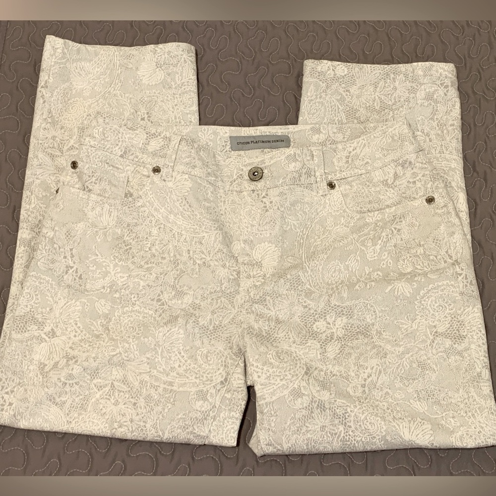 Chico’s Platinum Denim Capris 5 pockets, light gray background, white lace print